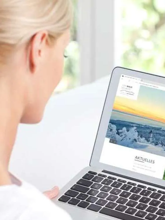 Frau sitzt vor Laptop